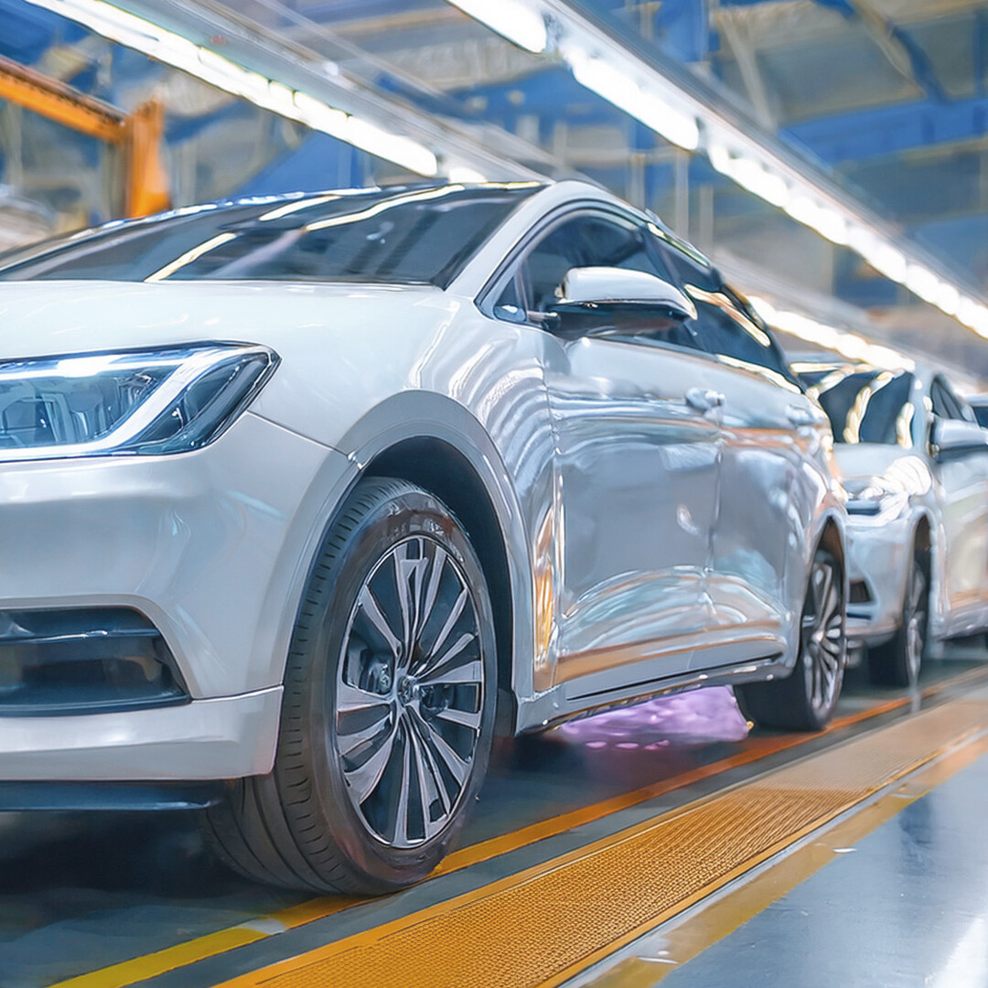 White vehicles on a modern production line in a production hall