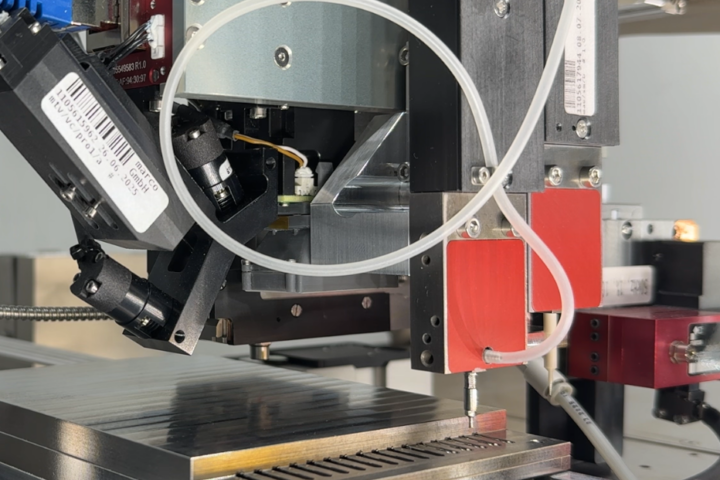 Detail of a dispensing head for placing small parts and dispensing UV adhesive.